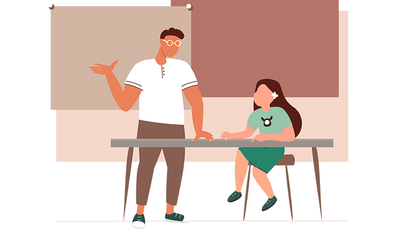 Assistant teacher have a one-to-one session with a student inside a classroom